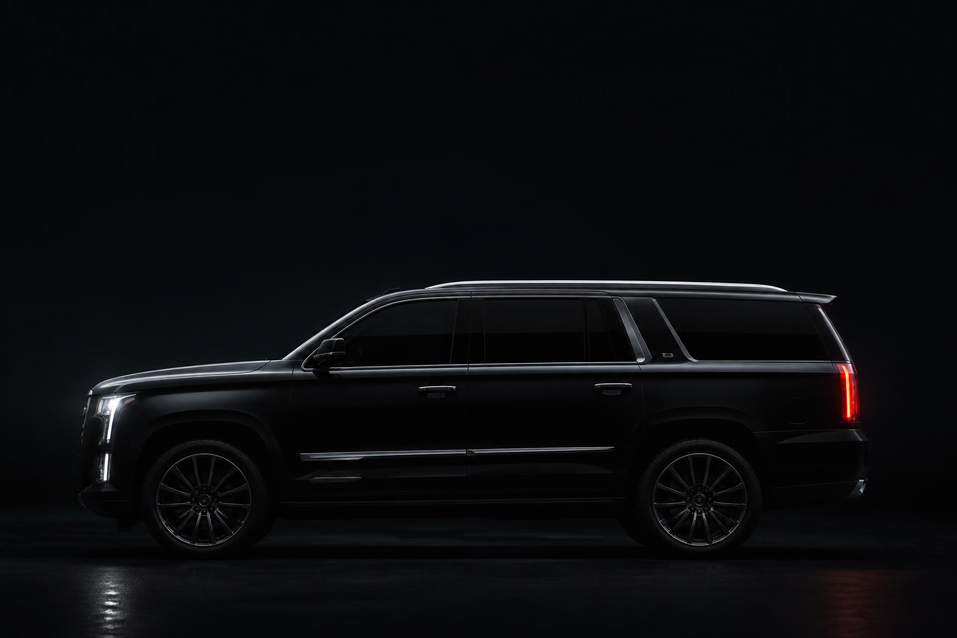 A BlackX executive SUV waiting at the curb in downtown San Antonio at night